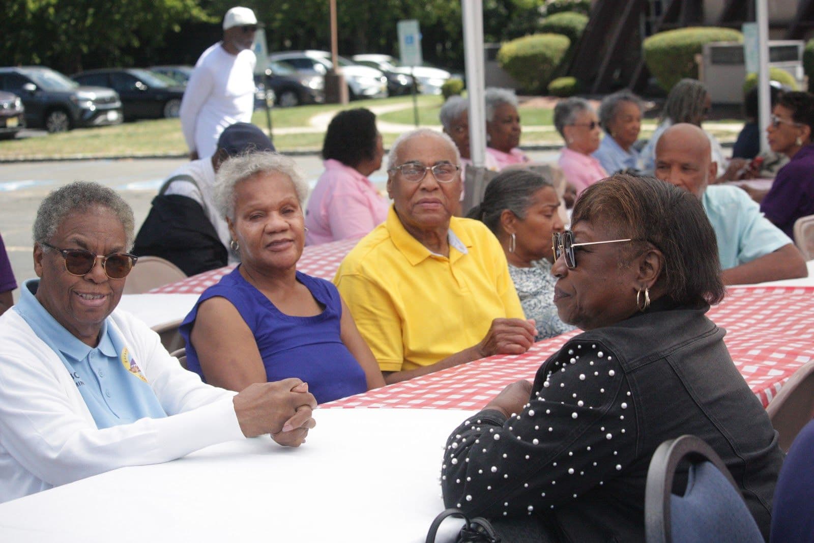 Members of St. John’s sharing a table and smiling after service.