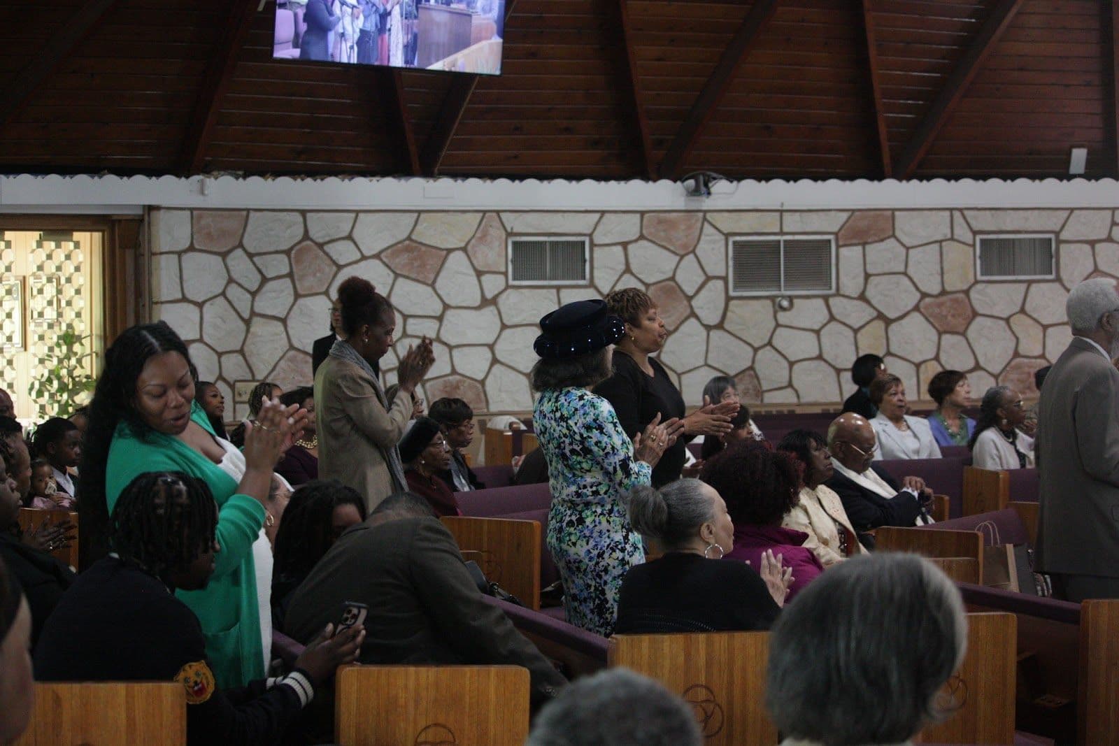 Members of St. John’s standing and singing together during Sunday worship