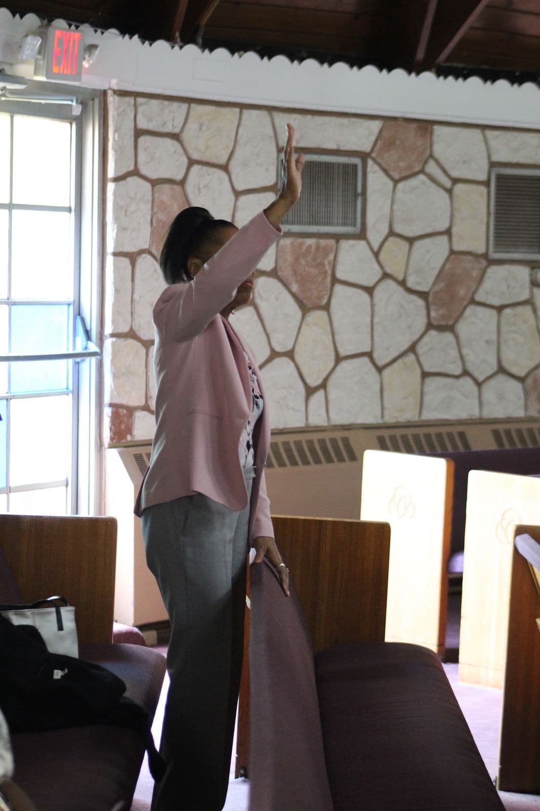 A member raising a hand in worship