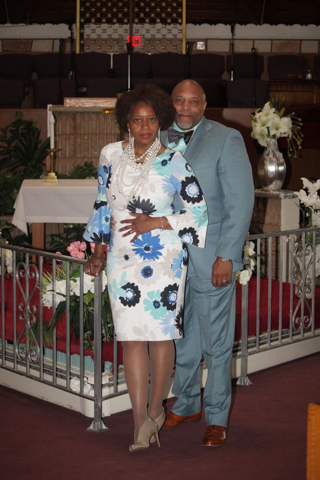 A couple walking together up the sanctuary aisle