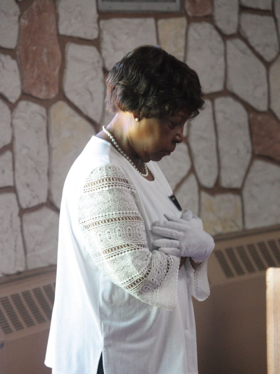 A member bowed in prayer in the sanctuary